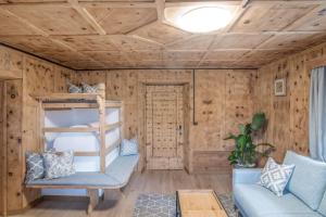 a room with a bunk bed and a couch at Pfitscherhof in Campo di Trens
