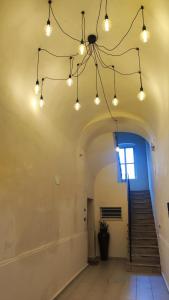 a hallway with lights and stairs in a building at Amalò Guest House in Bari