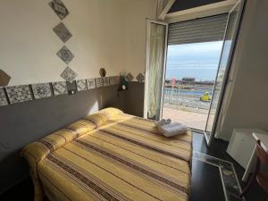 Ένα ή περισσότερα κρεβάτια σε δωμάτιο στο Piccolo Hotel di Lavagna