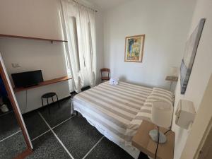 Ένα ή περισσότερα κρεβάτια σε δωμάτιο στο Piccolo Hotel di Lavagna