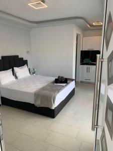 a bedroom with a large bed and a kitchen at petros house in Sarti