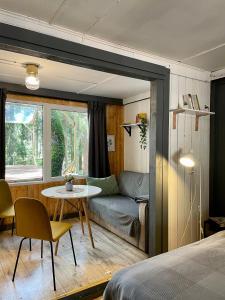 a room with a bed and a table and a couch at Lodge "Ezīša Midziņa" in Ķegums