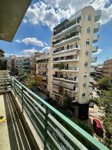 a tall building with balconies on the side of it at Vintage-style 2 bedroom apartment at Katechaki in Athens