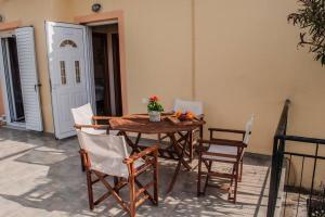 a wooden table and chairs in a patio at Phyllida Guest House - M4 in Zakharo