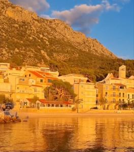 a group of buildings on the shore of a body of water at Apartmani Apollo - Drasnice in Drasnice