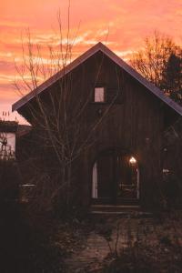 a barn with an open door at sunset at BnB chambres d'hôtes le Chêne in Ban-sur-Meurthe-Clefcy