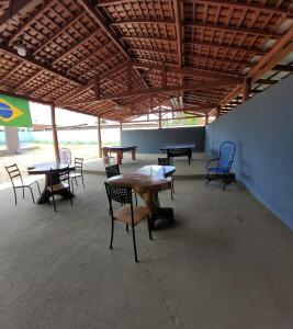 a group of tables and chairs in a room at POUSADA ALÉM-K in Riachão