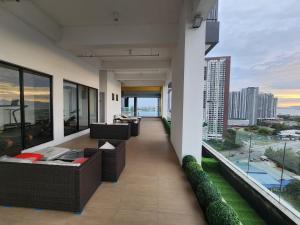 a balcony with couches and a view of the city at Praicon Executive Suite in Butterworth