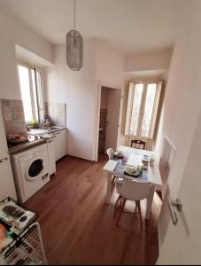 a kitchen with a table and a kitchen with a stove at Casetta Sapienza in Gaeta +20 photos