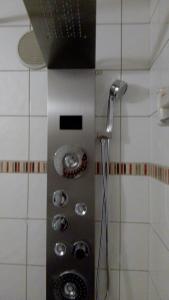 a shower with a shower head in a bathroom at appartement au pied des pistes in Valmorel