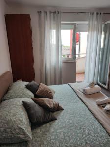 a bed with pillows on it in a bedroom at Jasmina in Senj