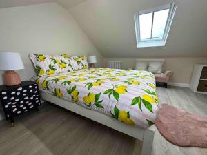 a bedroom with a bed with a colorful comforter at Impressive 3 bed cottage by the river in Stanhope in Stanhope