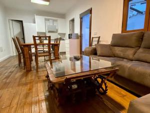 a living room with a couch and a coffee table at Casa Buitreras in El Colmenar +18 photos