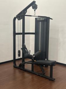 a black exercise machine sitting on a wooden floor at Chambers Suites KL in Kuala Lumpur