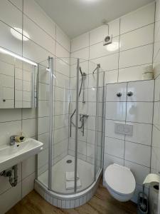 a bathroom with a shower and a toilet and a sink at AJO Vienna Messe - contactless check in in Vienna