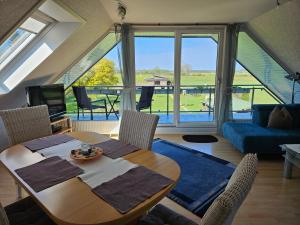 a living room with a table and chairs and a couch at Ferienwohnung Haus Rita in Glasau