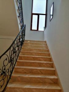 a staircase with a metal railing and a window at Casa Federica in Taviano