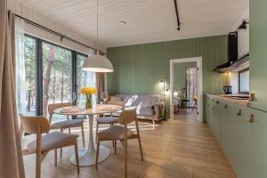a kitchen and living room with a table and chairs at Заміський комплекс - DOGODA in Dzvinkove