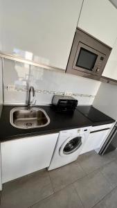 A kitchen or kitchenette at Elegant apartment next to the sea!