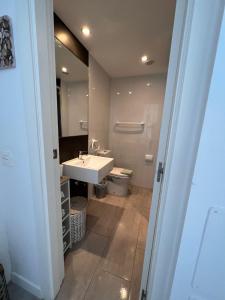 A bathroom at Elegant apartment next to the sea!