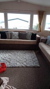 a living room with a couch and a rug at Crimdon dene bay view holiday home NO SMOKING NO PETS in Durham