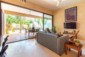 a living room with a couch and a table at Casa Esperanza Tulum Private Pool in Tulum