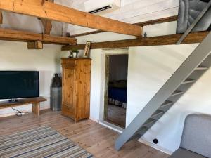 a living room with a staircase and a tv at Öja in Ystad