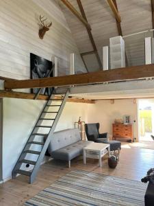 a living room with a loft bed and a couch at Öja in Ystad