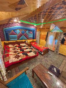 a bedroom with a bed and a table in it at Heritage Shreen Houseboat in Srinagar
