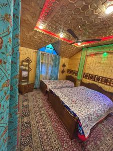 a bedroom with two beds in a house at Heritage Shreen Houseboat in Srinagar
