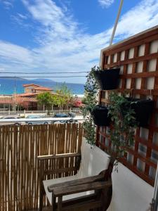 a balcony with a wooden fence and two benches at Farniente Tolo in Tolo