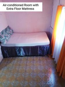 an air conditioned room with echo floor mattresses sidx sidx sidx at Tina Transient Home in Calayo