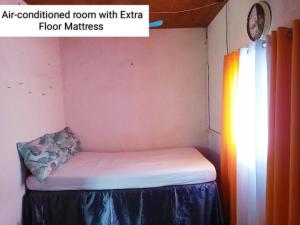 an air conditioned room with echo floor mattress in a room at Tina Transient Home in Calayo
