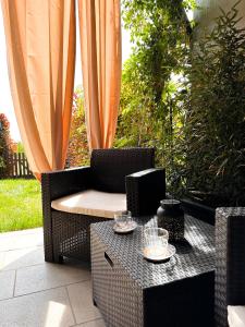 een rieten stoel en een tafel op een patio bij Langhe Wine & Relax in Novello
