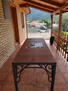 a table on a porch with a view of a patio at Villa Kassel in Stari Bar