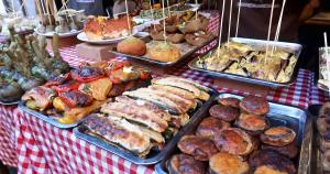 a table topped with trays of food and pastries at Montesanto House Palermo in Palermo