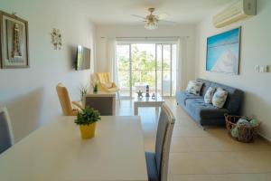 a living room with a table and a couch at Apartment in Dominicus in Bayahibe