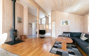 a living room with a blue couch and a stove at Rubinsen Skovhus in Hasle