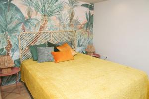 ein Schlafzimmer mit einem gelben Bett und bunten Kissen in der Unterkunft Sunshine Apartment Fuengirola in Fuengirola