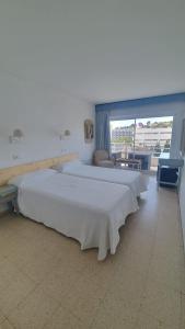 Postel nebo postele na pokoji v ubytování Hostal Roberto