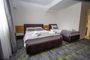 a room with two beds in a room at Hotel Grand in Banja Luka
