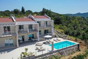 an aerial view of a villa with a swimming pool at Tilagus holiday villa - Nostromo in Žman