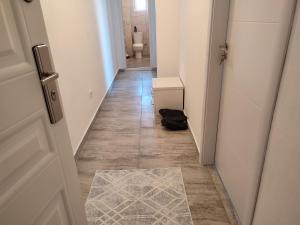a hallway with a door and a toilet in a bathroom at Sabi Apartment Golem Qerret in Golem +34 photos