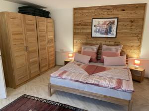 a bedroom with a large bed with two lamps on it at Ferienparadies Bodensee Fewo1 in Owingen