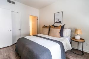 a bedroom with a large bed and a table at Spacious 2BR Near Santa Monica Beach, Walk Everywhere! in Los Angeles