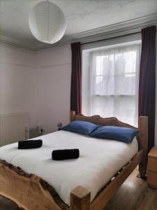 a bedroom with a large bed with a window at Brynawel in Aberystwyth