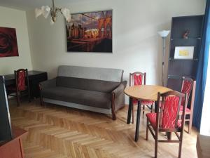 ワルシャワにあるZielony Żoliborzのリビングルーム(ソファ、テーブル、椅子付)