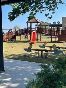 a park with a playground with a red slide at KALİDA APART in Kemer