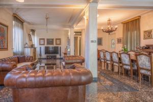 a living room with leather couches and a table and chairs at Villa Nautica in Herceg-Novi