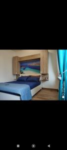 a bedroom with a bed and a blue curtain at Mar&Mar in Alghero